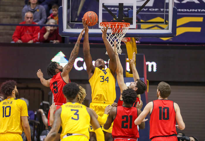 West Virginia Mountaineers forward Oscar Tshiebwe (34) shoots the ball over Austin Peay Governors guard Jordyn Adams (5) during the first half at WVU Coliseum.
